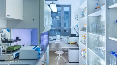 A pristine, sterile laboratory with gleaming surfaces and advanced equipment, symbolizing the controlled environment of CADR testing. This setting contrasts with the real-world effectiveness of Austin Air purifiers, which are clinically proven to improve health outcomes for people with respiratory conditions such as asthma and COPD.