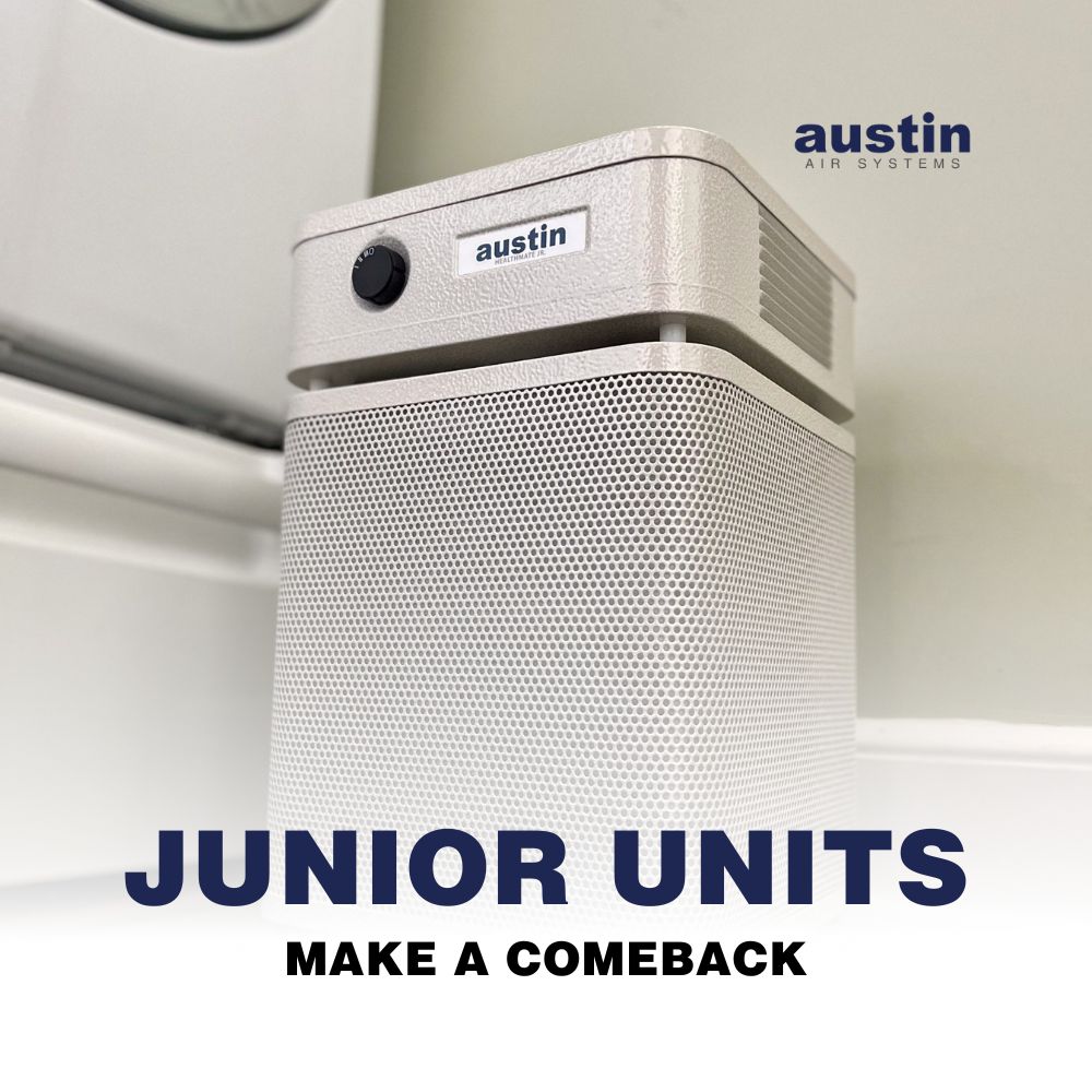 A photo of a sandstone (off-white) Austin Air HealthMate Jr. air purifier in a lightly colored room.