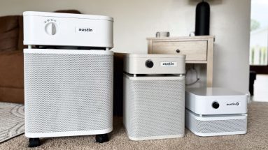 Three Austin Air purifiers, one in each size: standard, junior, and the "it" personal air purifier.